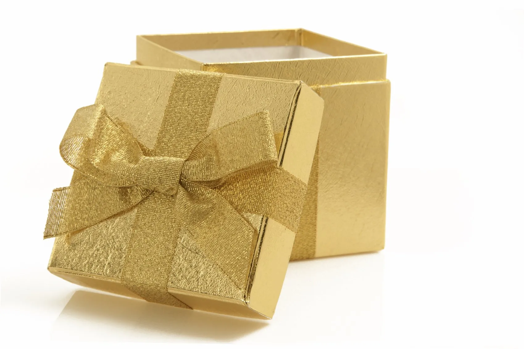 A gold gift box with a bow on a white background