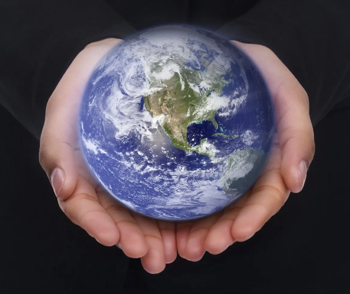 A pair of hands holds the Earth in them.
