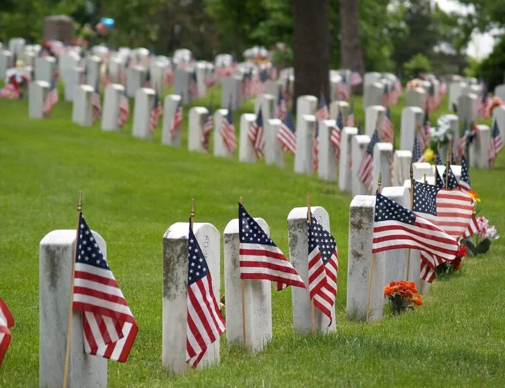 A graveyard for soldiers with American flags displayed at each one for Memorial Day.