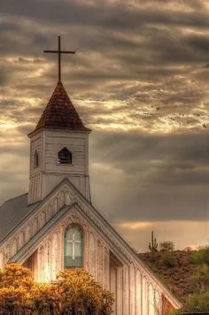 A rural church with clouds in the background