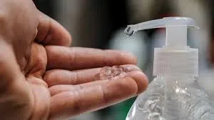 A person's hand dispensing hand sanitizer to use.