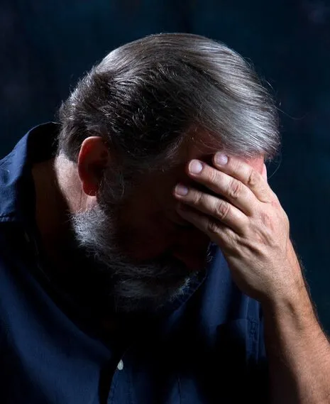 A man with his head in his hand