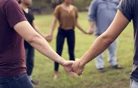 People in a circle holding hands