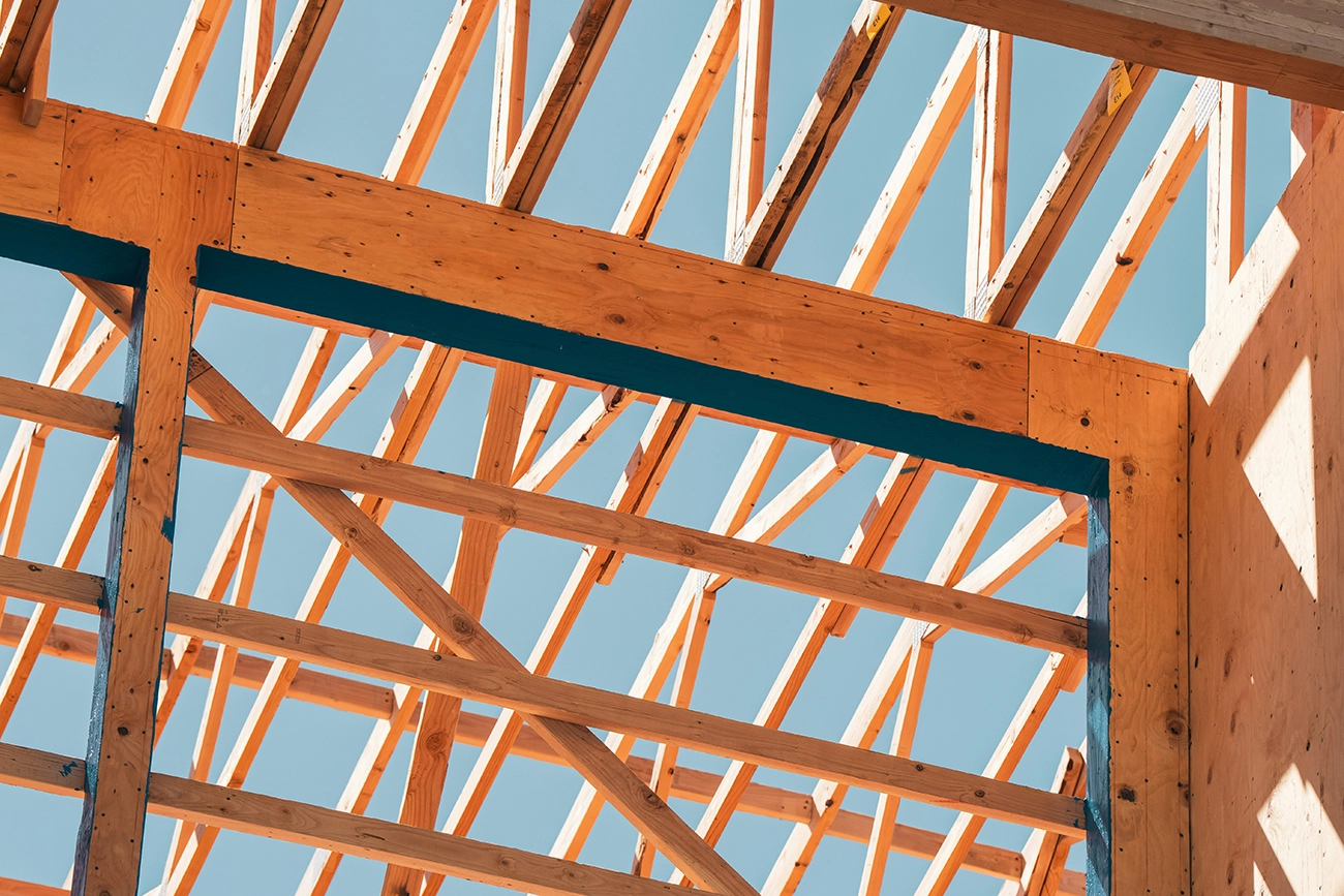 A new construction midway through its labor, with wooden beams forming the skeleton of a building